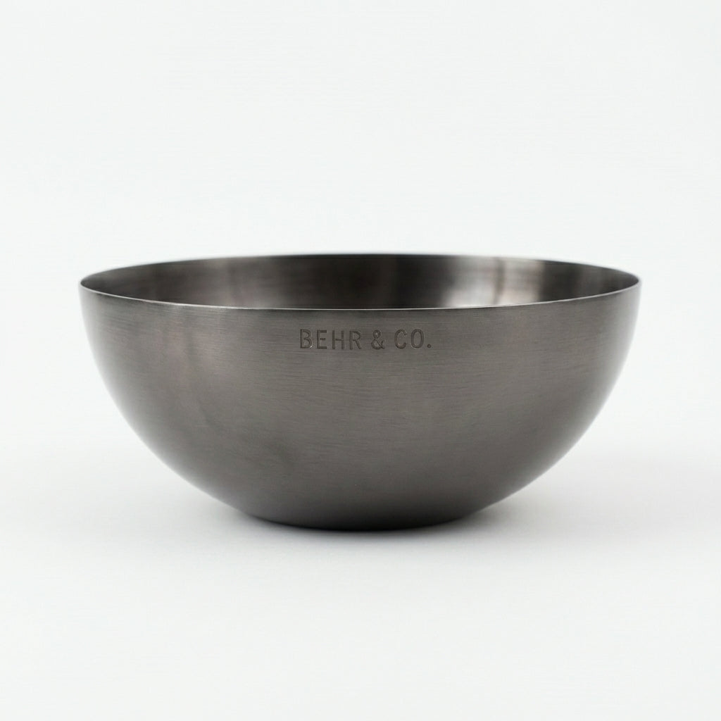 Stainless steel bowl with 'BEHR & CO.' engraving on a white background