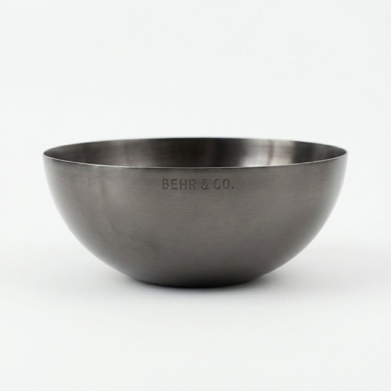 Stainless steel bowl with 'BEHR & CO.' engraving on a white background