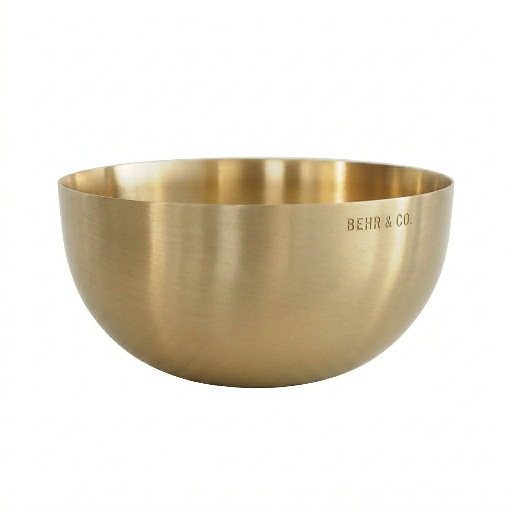 Gold bowl with 'BEHR & CO.' engraving on a white background