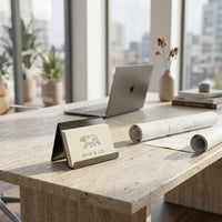 Modern office desk with black nickel business card holder and a view of cityscape