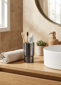 Bathroom counter with a white sink, wooden cabinet, and various toiletries.