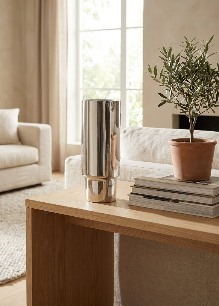 Modern living room with a wooden coffee table, decorative vase, and plant.