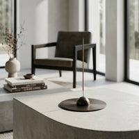Modern interior with an incense holder placed on a nice black nickel coaster.