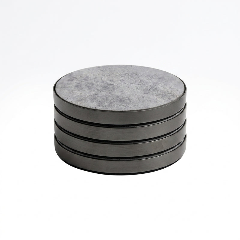 Set of four round stone coasters with a black metal rim on a white background