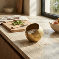 Gold bowl on a kitchen counter with natural light