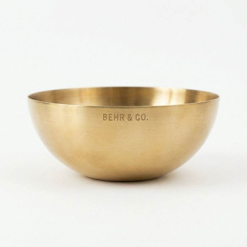 Gold bowl with 'BEHR & CO.' engraving on a white background